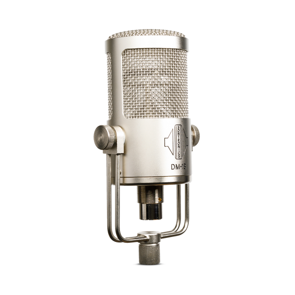 An image on white blackground of a silver-champagne coloured Sontronics DM-1B microphone facing to the right, its chunky cylindrical body sitting in a U-shaped yoke mount that fixes with two thumbscrews to the right and left. The upper two-thirds of the mic is a grille mesh head through which can just be seen the horizontally mounted capsule