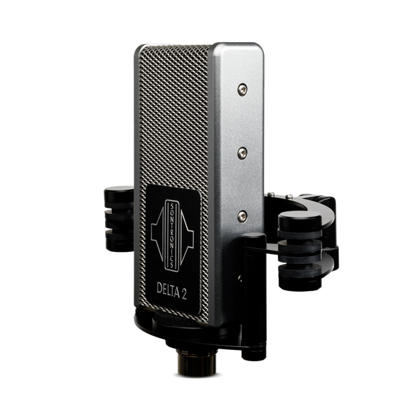 Image on white background of Sontronics Delta 2 microphone facing slightly to the left. The rectangular body with its silver mesh grille and silver side panels has a black plate on the front engraved with a silver logo and silver 'Delta 2' name. The microphone sits in its shockmount with two side supports and rear arcs, with the stand mount connector lever just visible