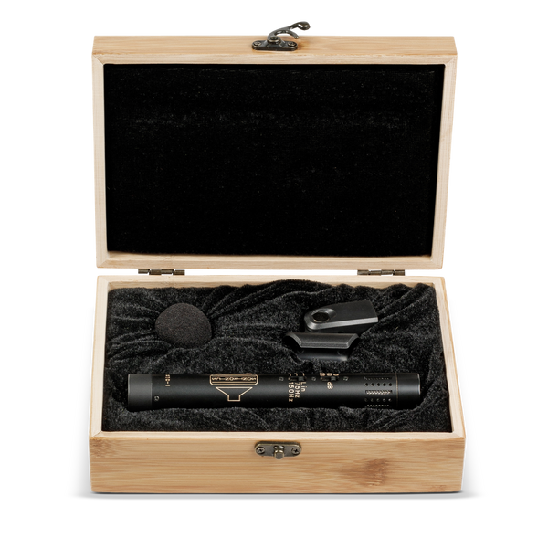 Image on white background of an opened wooden, velvet-lined box, inside is a black Sontronics STC-1 pencil style microphone, a microphone clip and a small foam windshield