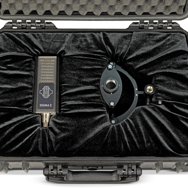 Image on white background of an open black flightcase with velvet lining in which sits a Sontronics Sigma 2 microphone and to the right its shockmount